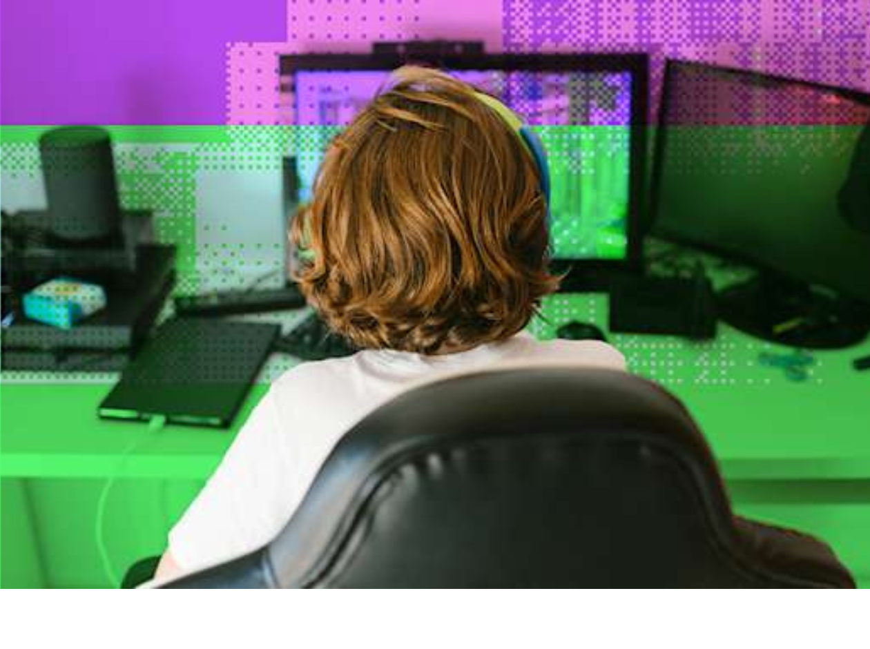 Young person in front of monitors